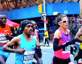 Two runners competing in a street marathon event.