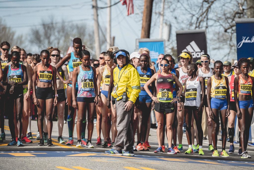 Runners lined up at the start of a race, focused and ready.