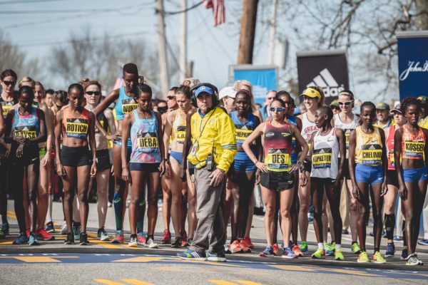 Runners lined up at the start of a race, focused and ready.