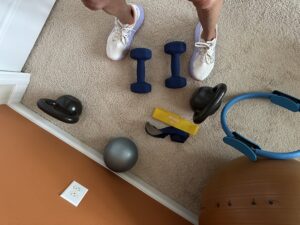 Person inside a vehicle wearing goggles and making a peace sign.
