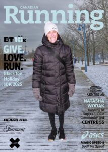 Person inside a vehicle wearing goggles and making a peace sign.